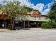 Exterior of Cafe Alfresco with striped awning, signage, and street parking at 702 Lyndhurst St # 822, Dunedin, FL 34698