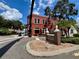 Shops on Broadway brick building with well-maintained landscaping and street view at 702 Lyndhurst St # 822, Dunedin, FL 34698