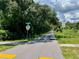 Paved trail flanked by trees and signage along Lyndhurst St with a designated speed limit at 702 Lyndhurst St # 822, Dunedin, FL 34698