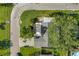 Aerial view of a well-maintained home, featuring a spacious driveway and a beautiful green yard at 7400 Locust Ne St, St Petersburg, FL 33702
