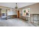 Dining area with chandelier and window, offering potential for renovation and customization at 7400 Locust Ne St, St Petersburg, FL 33702