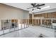 Open-concept kitchen area with tile flooring and ceiling fan ready for renovation at 7400 Locust Ne St, St Petersburg, FL 33702
