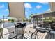 Relaxing back deck overlooking the water, featuring comfortable seating and a screened-in lanai for enjoying the serene views at 805 Leisey Cir, Ruskin, FL 33570