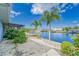 The landscaped backyard has a waterfront view and a private dock and deck at 805 Leisey Cir, Ruskin, FL 33570