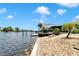 A beautiful backyard with a patio, tropical landscaping, and waterfront access, creating a serene and inviting outdoor space at 805 Leisey Cir, Ruskin, FL 33570