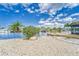 Features a backyard with tropical landscaping, a waterfront view, and a private dock at 805 Leisey Cir, Ruskin, FL 33570