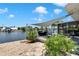 Backyard with a patio, screened-in lanai, and lush tropical foliage, perfect for outdoor entertaining or relaxing by the water at 805 Leisey Cir, Ruskin, FL 33570