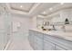 Bright bathroom featuring a double vanity with marble countertop and a glass-enclosed shower at 805 Leisey Cir, Ruskin, FL 33570