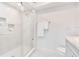 Bright bathroom with a glass shower enclosure, tiled walls, and white marble flooring at 805 Leisey Cir, Ruskin, FL 33570