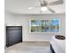 Bright bedroom boasts hardwood floors, serene views, and a modern ceiling fan at 805 Leisey Cir, Ruskin, FL 33570
