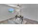 A bright bedroom with wood flooring, a ceiling fan, and a view of the water at 805 Leisey Cir, Ruskin, FL 33570
