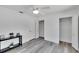 Bright bedroom features neutral paint, wood-look floors, modern ceiling fan, and closet storage at 805 Leisey Cir, Ruskin, FL 33570