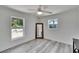 Bedroom featuring hardwood floors, ceiling fan, and views from two windows at 805 Leisey Cir, Ruskin, FL 33570