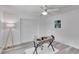 Bright bedroom with wood floors, ceiling fan, and modern writing desk at 805 Leisey Cir, Ruskin, FL 33570