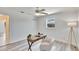 Bright bedroom with wood floors, ceiling fan, and modern writing desk at 805 Leisey Cir, Ruskin, FL 33570