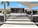 Features a spacious deck with outdoor seating and waterfront access and a screened-in lanai at 805 Leisey Cir, Ruskin, FL 33570
