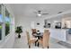 Dining area with wicker chairs, modern ceiling fan, and open view to the kitchen at 805 Leisey Cir, Ruskin, FL 33570