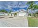 Single-story home with a brick-paved driveway, low maintenance landscaping, and a two-car garage at 805 Leisey Cir, Ruskin, FL 33570
