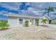Well-maintained front entrance with decorative stone landscaping and manicured shrubbery at 805 Leisey Cir, Ruskin, FL 33570