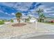 Single-story home featuring low maintenance landscaping, a long driveway and mature palm trees at 805 Leisey Cir, Ruskin, FL 33570