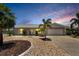 Charming home with manicured landscaping, decorative stone, and a well-lit entryway at twilight at 805 Leisey Cir, Ruskin, FL 33570