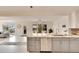 Open-concept kitchen featuring stainless steel appliances, gray cabinets, and bright living area with water view at 805 Leisey Cir, Ruskin, FL 33570