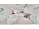 Bright living room showcasing neutral colors, white sofas, and ceiling fan at 805 Leisey Cir, Ruskin, FL 33570