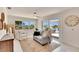 Bright living room with waterfront views, comfortable seating, and a sliding glass door to an outdoor patio at 805 Leisey Cir, Ruskin, FL 33570