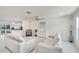 Bright living room featuring white sofas, ceiling fan, and decor against neutral colors at 805 Leisey Cir, Ruskin, FL 33570