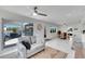 Living room with open floor plan, sliding door to patio, and views of the waterfront at 805 Leisey Cir, Ruskin, FL 33570