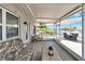 Inviting covered porch with relaxing seating overlooking waterfront at 805 Leisey Cir, Ruskin, FL 33570