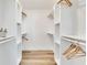 Walk-in closet with organized shelving and hardwood floors at 805 Leisey Cir, Ruskin, FL 33570