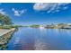 Serene canal waters and waterfront view from the property, enhanced by the lush green foliage and clear blue skies at 805 Leisey Cir, Ruskin, FL 33570