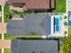 This aerial view showcases a home with a private pool and well-maintained landscaping, nestled between neighboring houses at 8148 Artisan Cir, Seminole, FL 33777