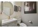 Contemporary powder room with a stylish vanity, gold accents, and modern lighting at 8148 Artisan Cir, Seminole, FL 33777