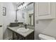 A bathroom featuring a granite countertop, modern fixtures, and neutral decor at 8148 Artisan Cir, Seminole, FL 33777