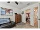 Bedroom with a wooden dresser, a ceiling fan, and a closet, offering a cozy and functional space at 8148 Artisan Cir, Seminole, FL 33777