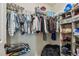 An organized walk-in closet featuring ample hanging space, shelving, and wire storage racks at 8148 Artisan Cir, Seminole, FL 33777