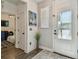 Bright foyer features wood look floors and a white front door with glass panels at 8148 Artisan Cir, Seminole, FL 33777