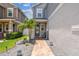 View of the entrance and front yard with brick pavers, lush landscaping, and gray stone at 8148 Artisan Cir, Seminole, FL 33777
