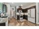 The kitchen features dark cabinets, stainless steel appliances, subway tile backsplash, and granite countertops at 8148 Artisan Cir, Seminole, FL 33777