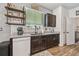 This kitchen features dark wood cabinets, granite counters and modern appliances near a window shelf at 8148 Artisan Cir, Seminole, FL 33777