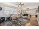 Spacious living room with ample seating, hardwood floors, and large windows at 8148 Artisan Cir, Seminole, FL 33777