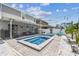 Backyard featuring an in-ground pool and spa, lounge seating, and privacy landscaping at 8148 Artisan Cir, Seminole, FL 33777