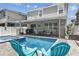 Backyard with a gorgeous in-ground pool and spa, a safety fence, and lounge seating at 8148 Artisan Cir, Seminole, FL 33777
