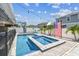 Backyard showcasing an in-ground pool and spa, lounge seating, privacy landscaping, and decor at 8148 Artisan Cir, Seminole, FL 33777