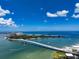 Beautiful view of waterfront condo complex, bridge, city and ocean from above on a clear, sunny day at 825 S Gulfview Blvd # 104, Clearwater Beach, FL 33767