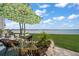 Inviting outdoor space with comfortable seating, mature landscaping and views of the Gulf of Mexico at 825 S Gulfview Blvd # 104, Clearwater Beach, FL 33767