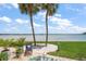 Gorgeous backyard featuring brick pavers, beautiful plants and lawn, with stunning views of the ocean at 825 S Gulfview Blvd # 104, Clearwater Beach, FL 33767