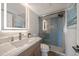 Modern bathroom features a vanity with LED mirror and a glass-enclosed shower with tile accents at 825 S Gulfview Blvd # 104, Clearwater Beach, FL 33767